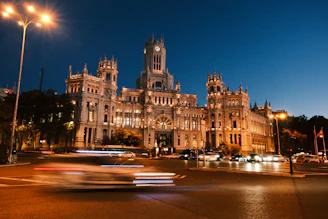 A large building with a clock tower at night