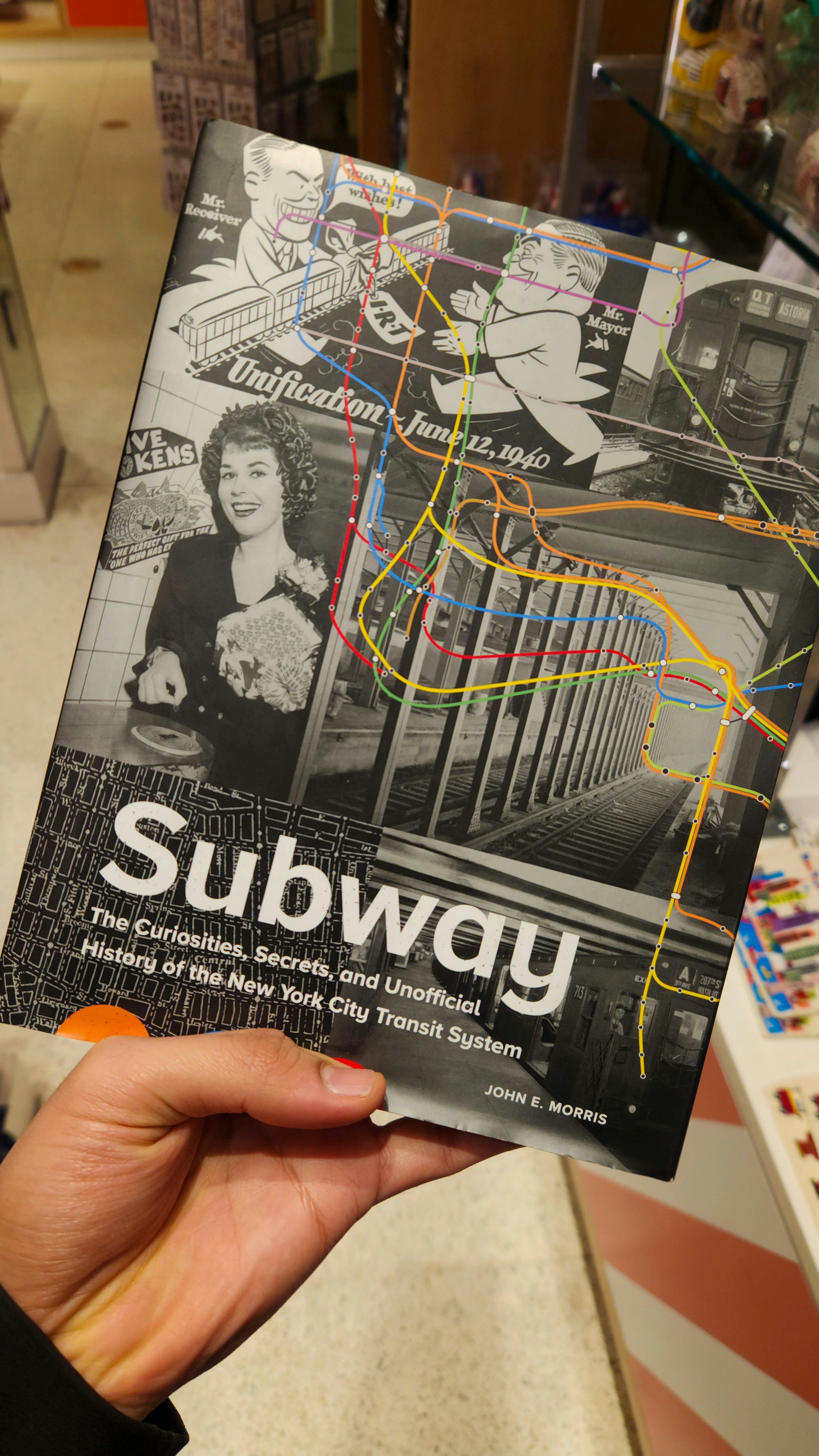 A person holding up a subway map in a store