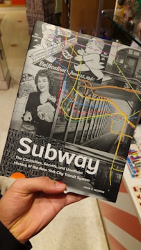 A person holding up a subway map in a store