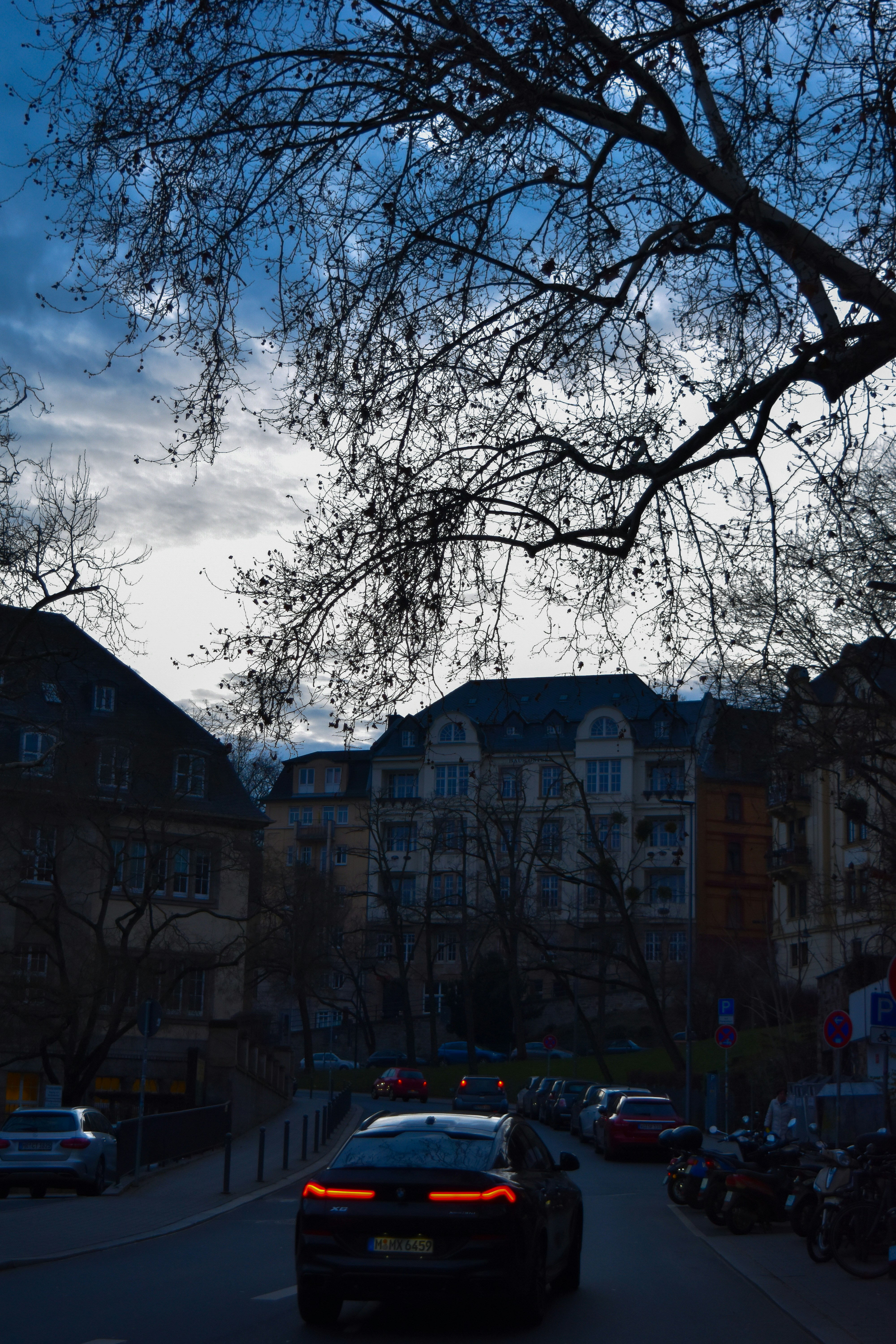 A car driving down a street next to tall buildings