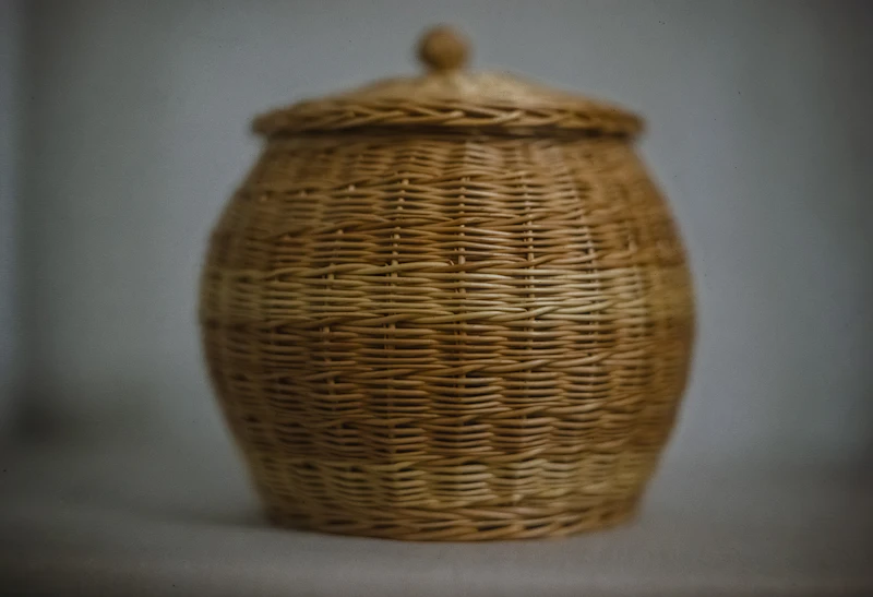 A wicker basket with a lid on a table