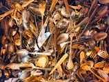A pile of silverware and forks and spoons