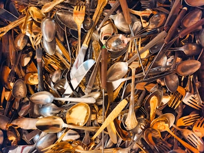 A pile of silverware and forks and spoons