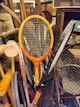A pile of tennis racquets sitting on top of a table