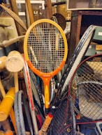 A pile of tennis racquets sitting on top of a table