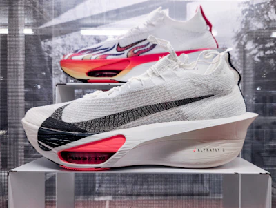 A pair of shoes on display in a glass case