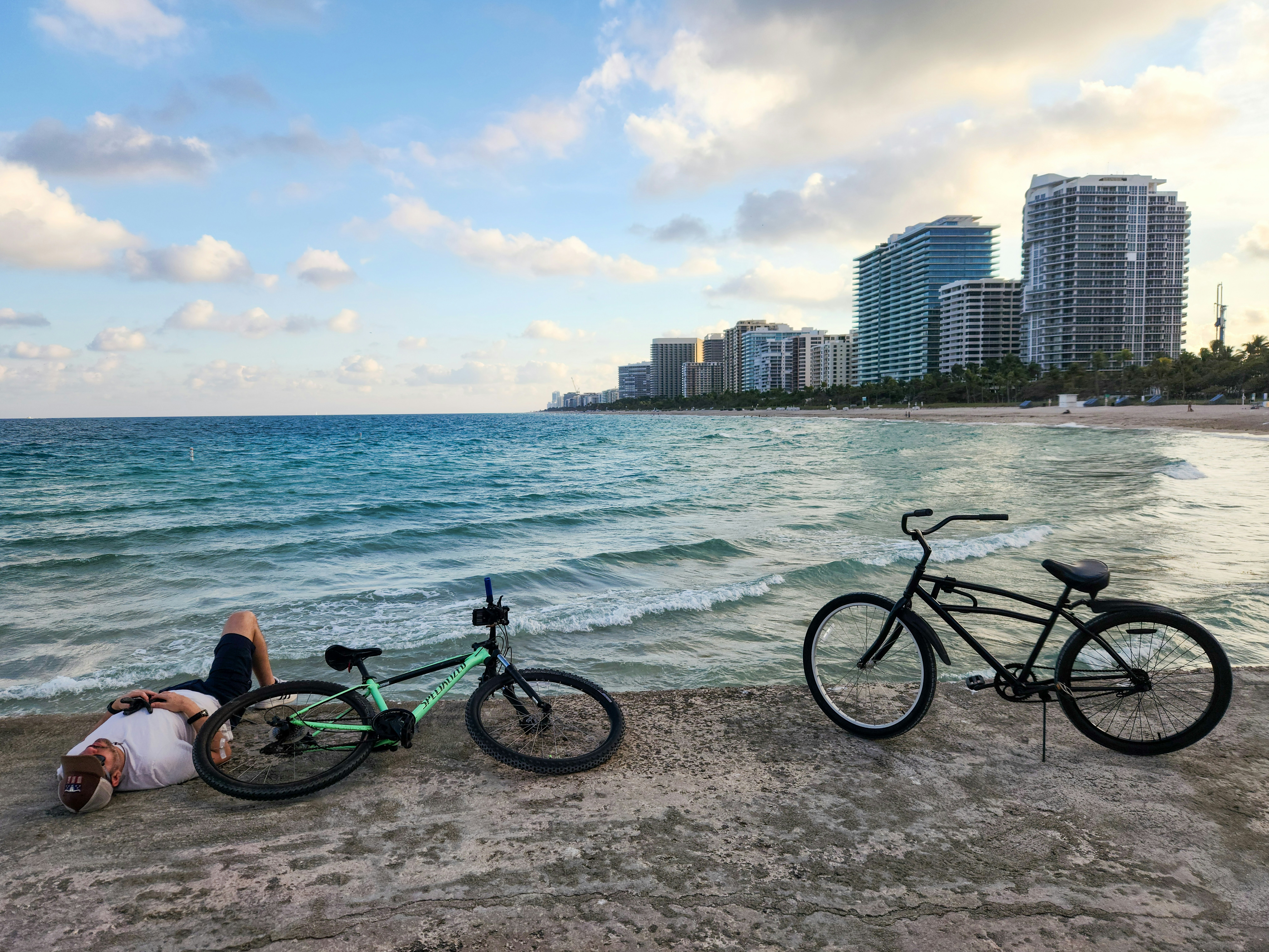 A couple of bikes sitting on top of a sandy beach