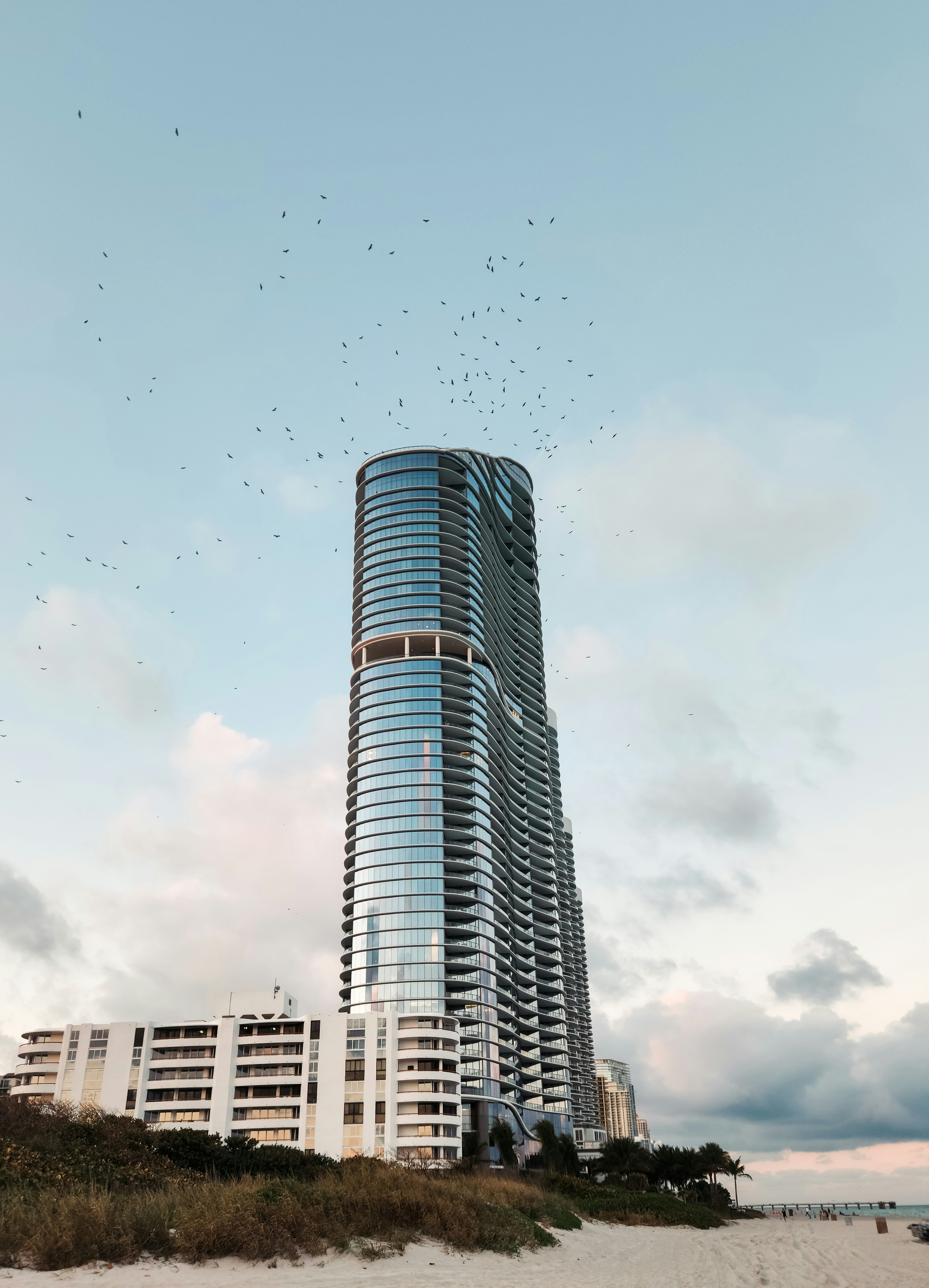 A tall building sitting on top of a sandy beach