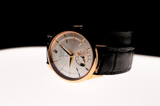 A watch sitting on top of a white table