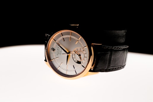 A watch sitting on top of a white table