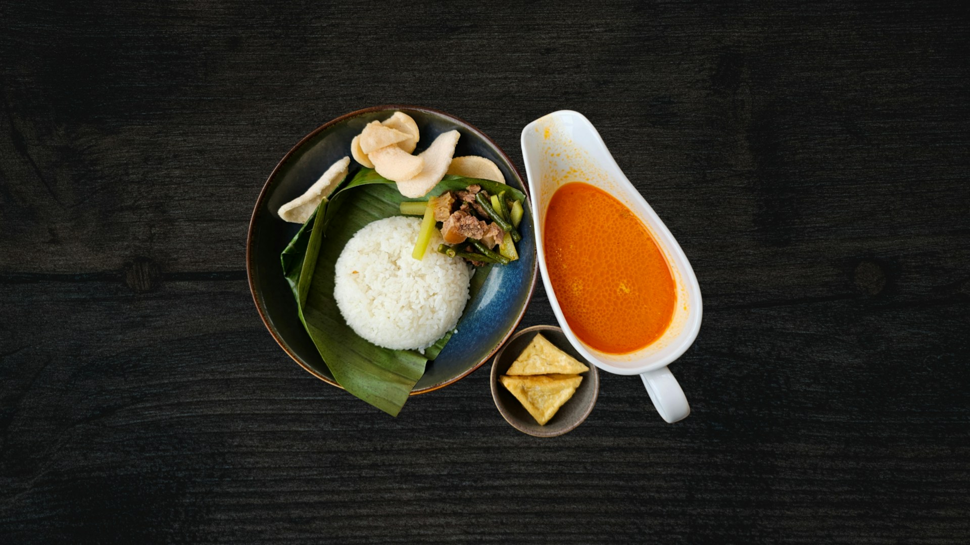 A bowl of soup and a plate of food on a table