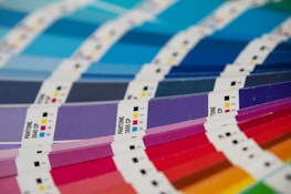 A bunch of different colors of paper on a table