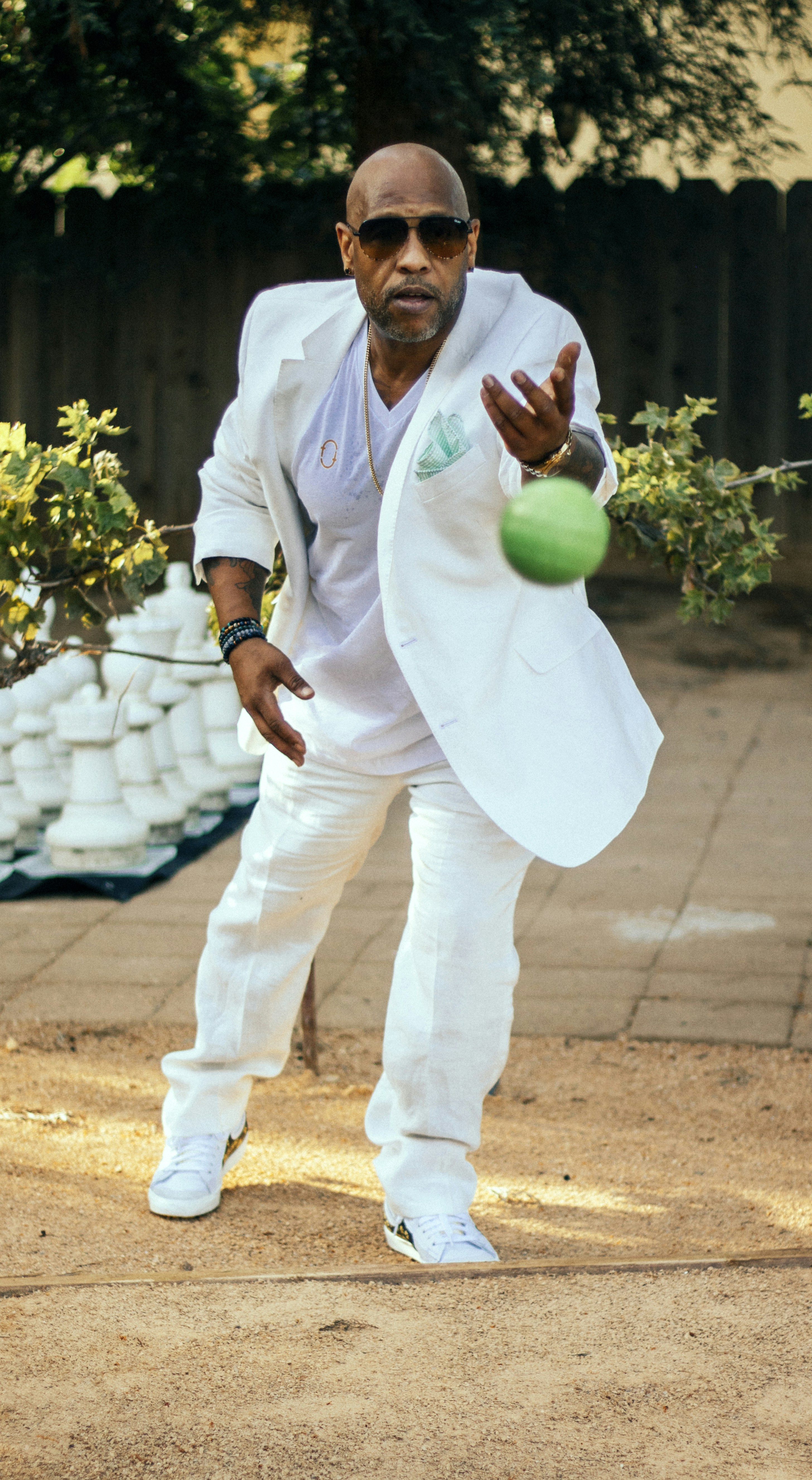 A man in a white suit is playing tennis