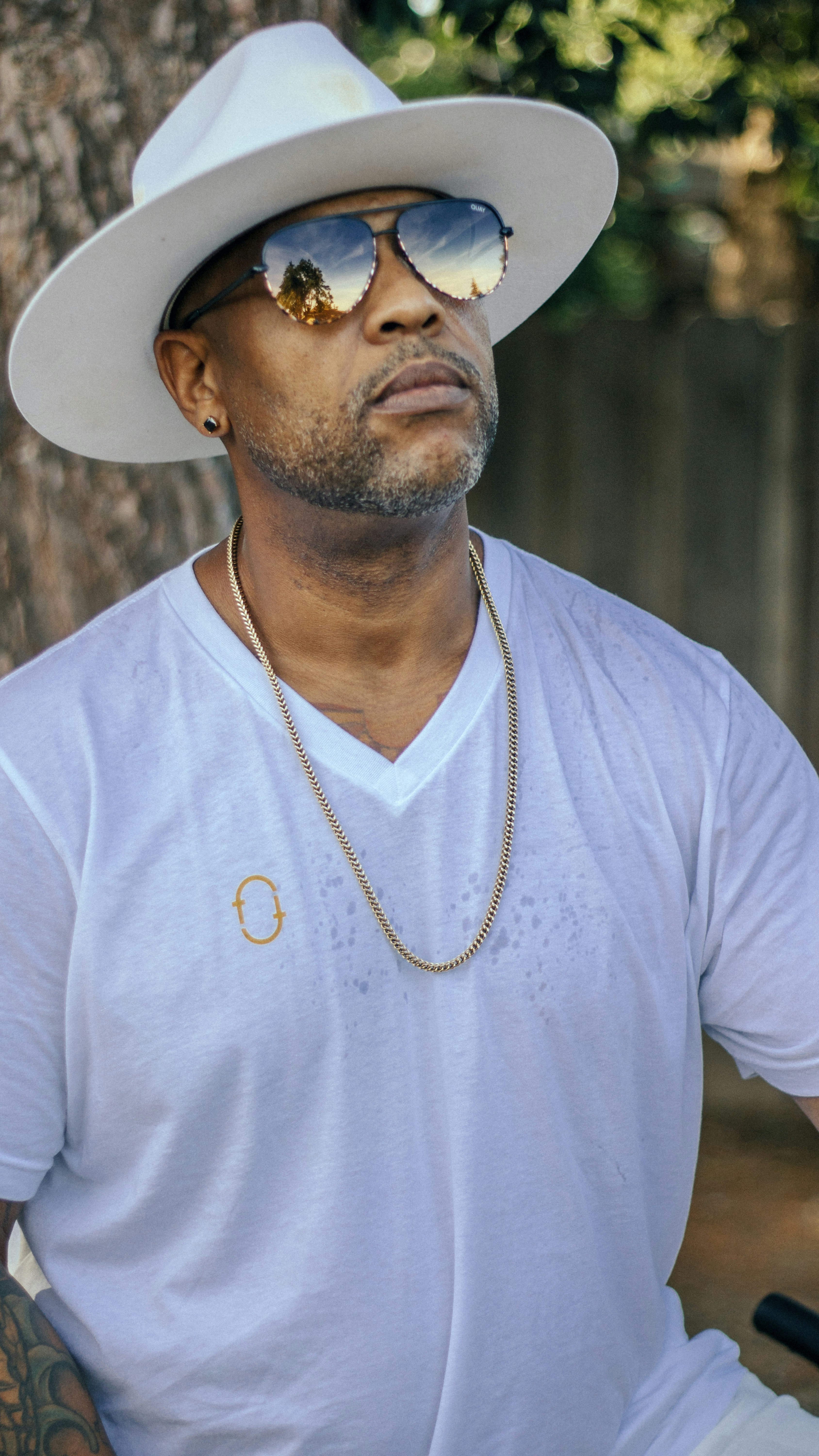 A man wearing a white hat and sunglasses