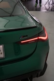 A close up of the tail light of a green car