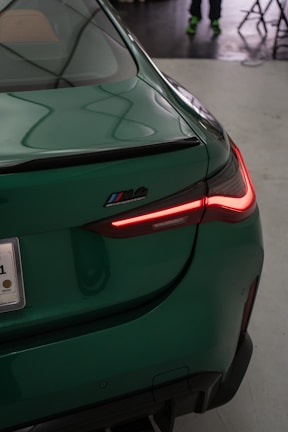 A close up of the tail light of a green car