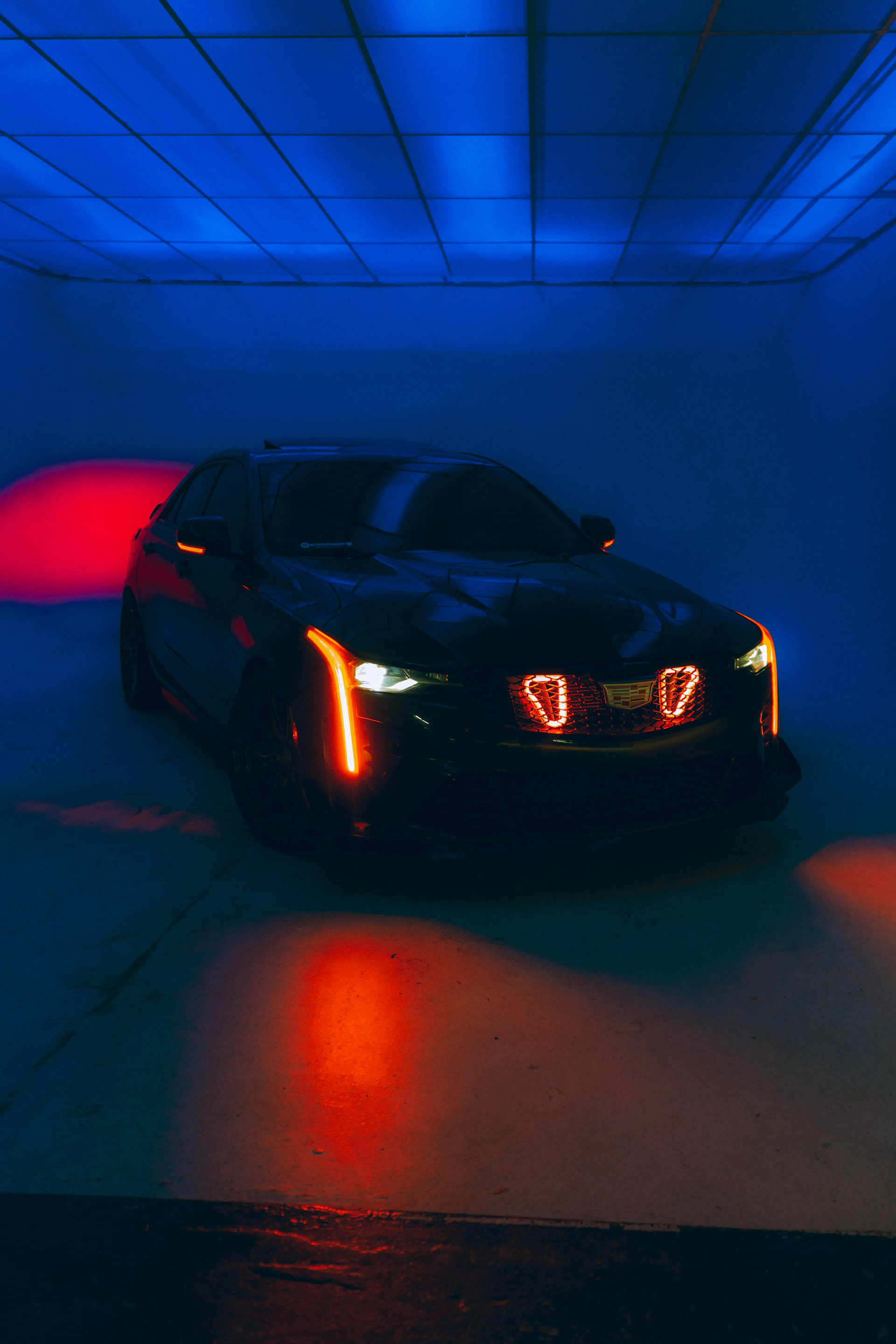 A car is shown in a dimly lit room