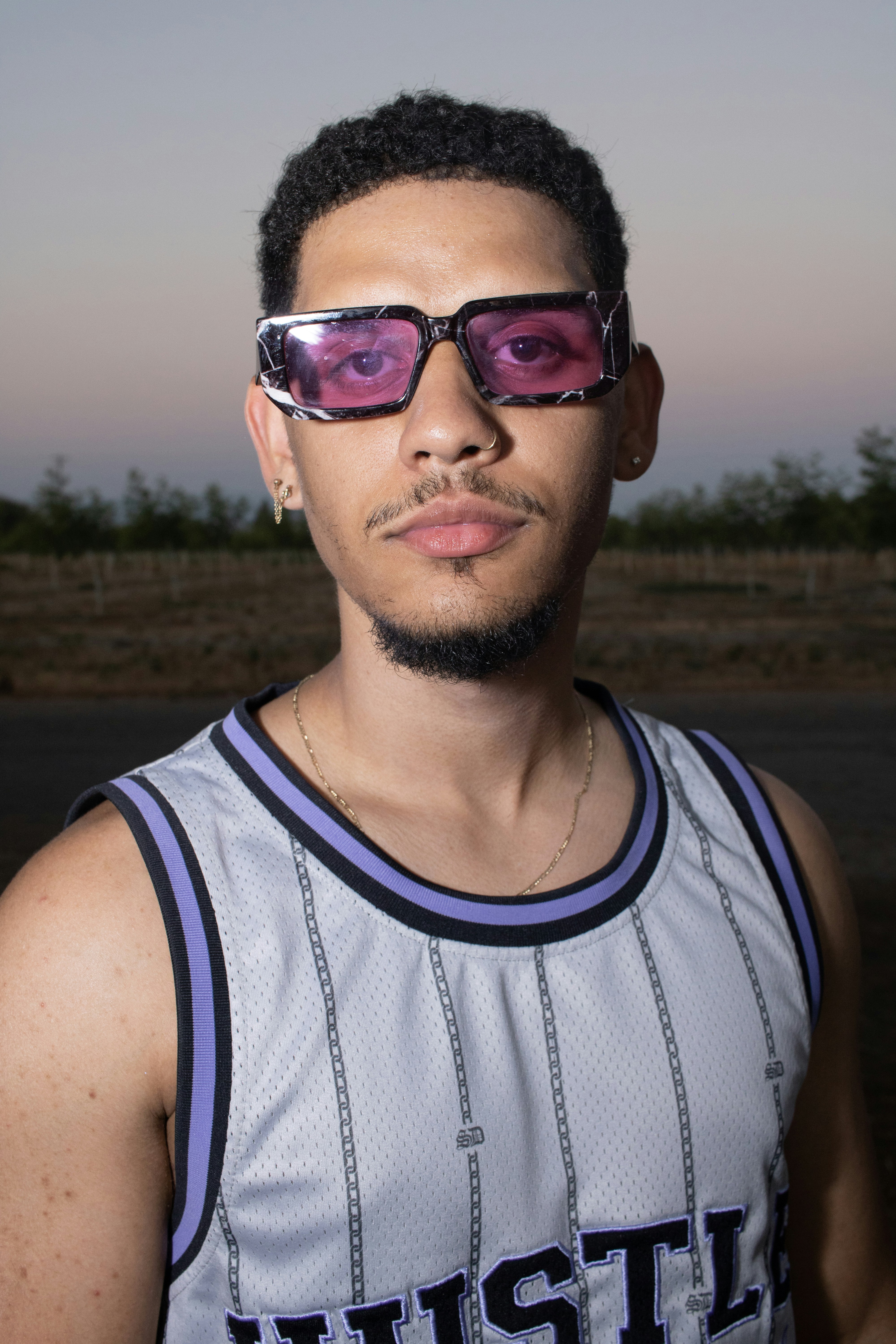 A man wearing sunglasses and a tank top