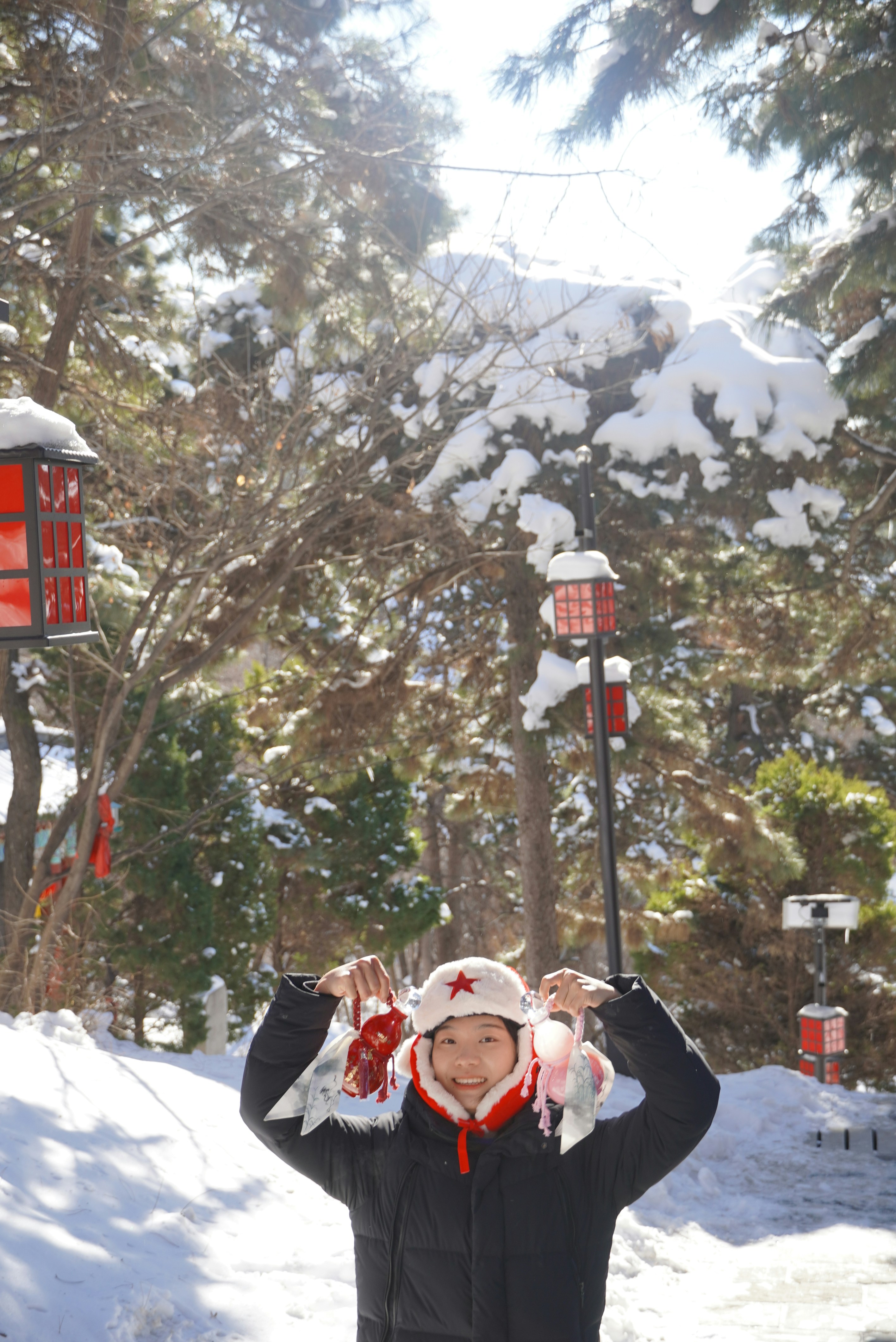 A man standing in the snow with his hands up