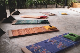 A group of yoga mats sitting on top of a cement floor