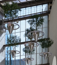 A building with a bunch of plants hanging from the side of it