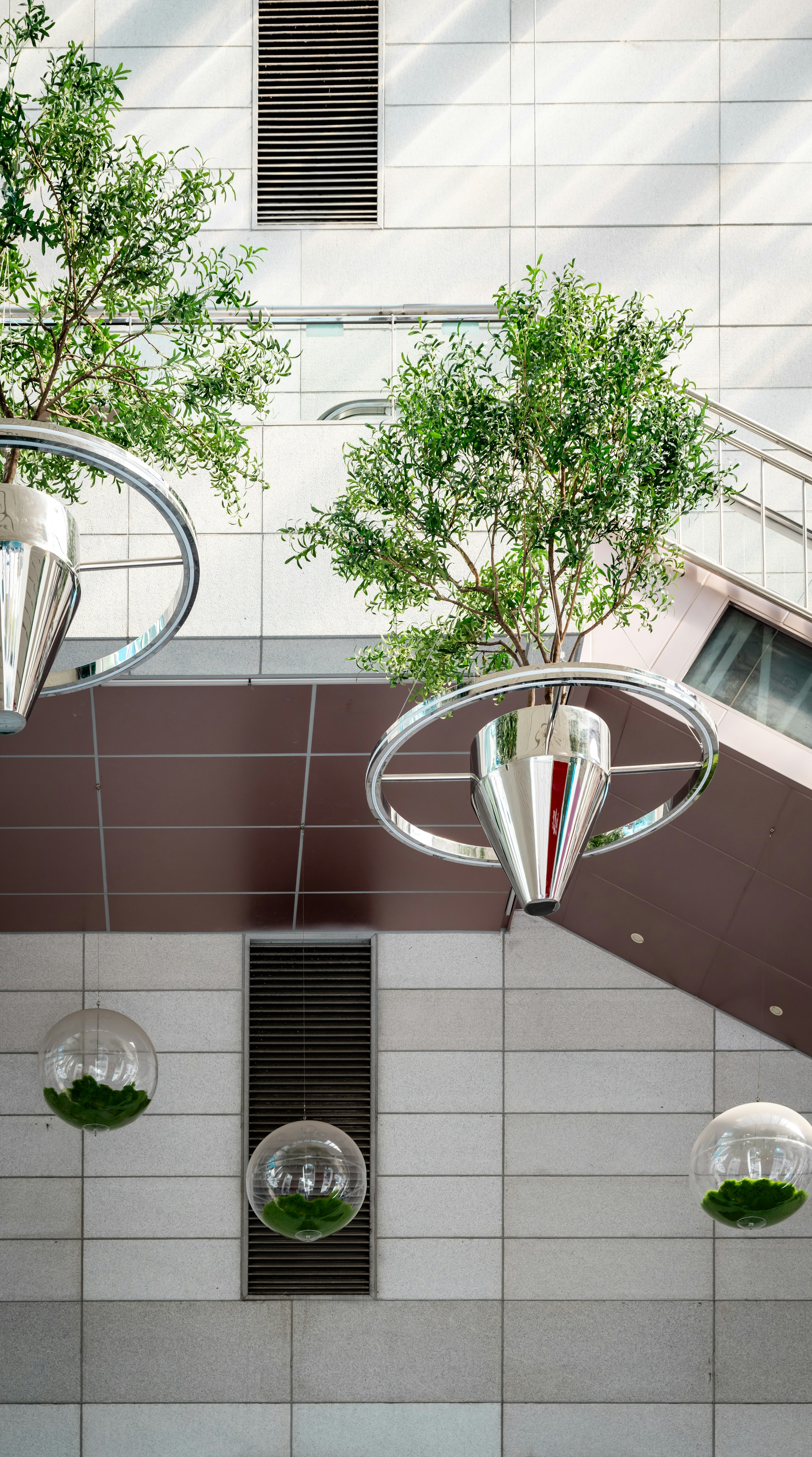A group of mirrors hanging from the side of a building