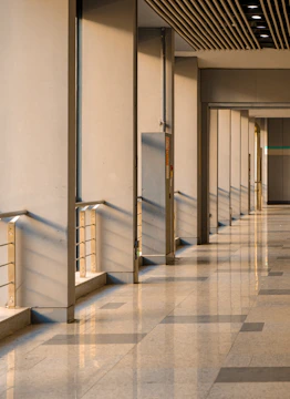 A long hallway with a clock on the wall