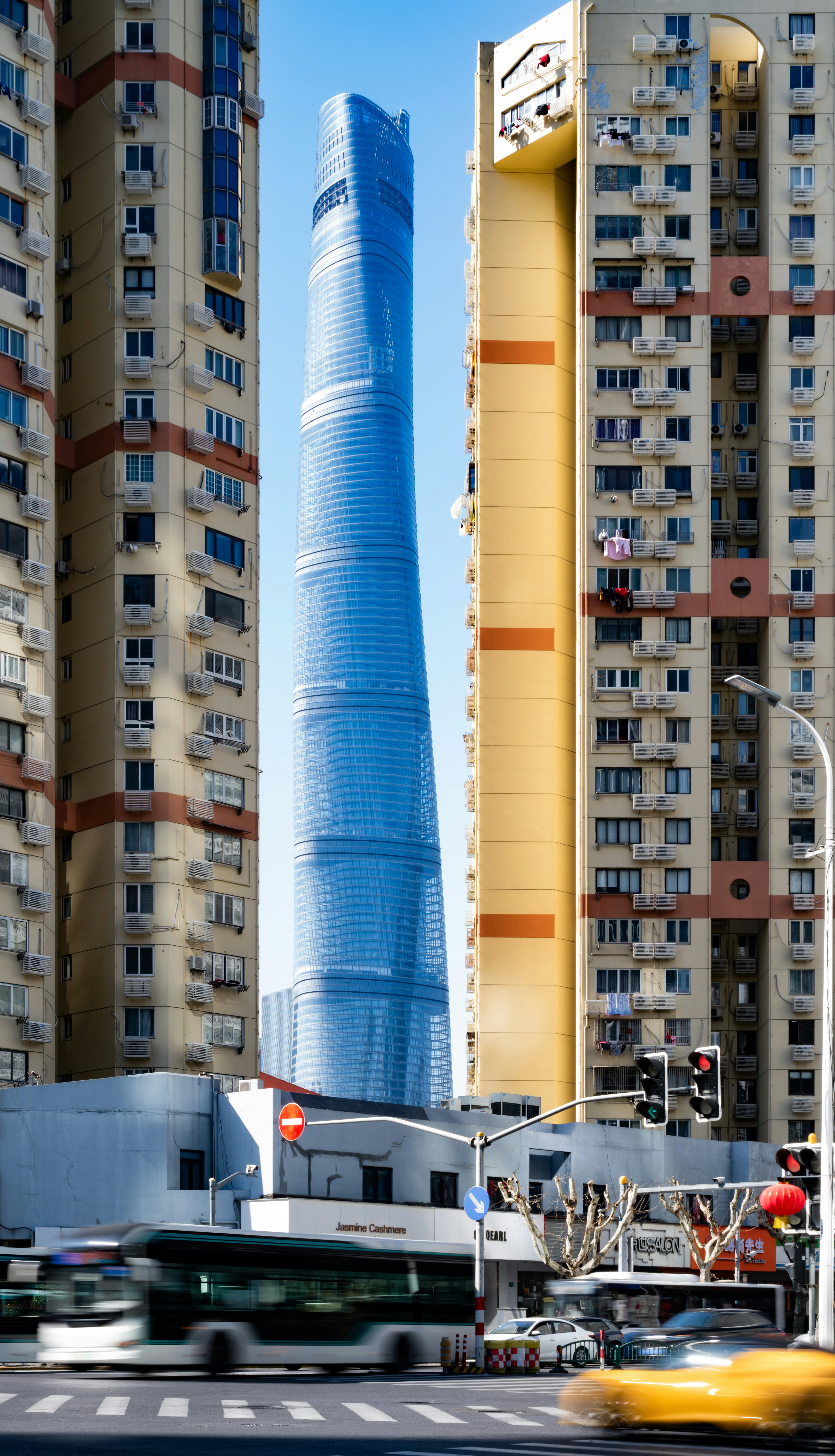 A very tall building towering over a city photo – Free Pudong Image on ...