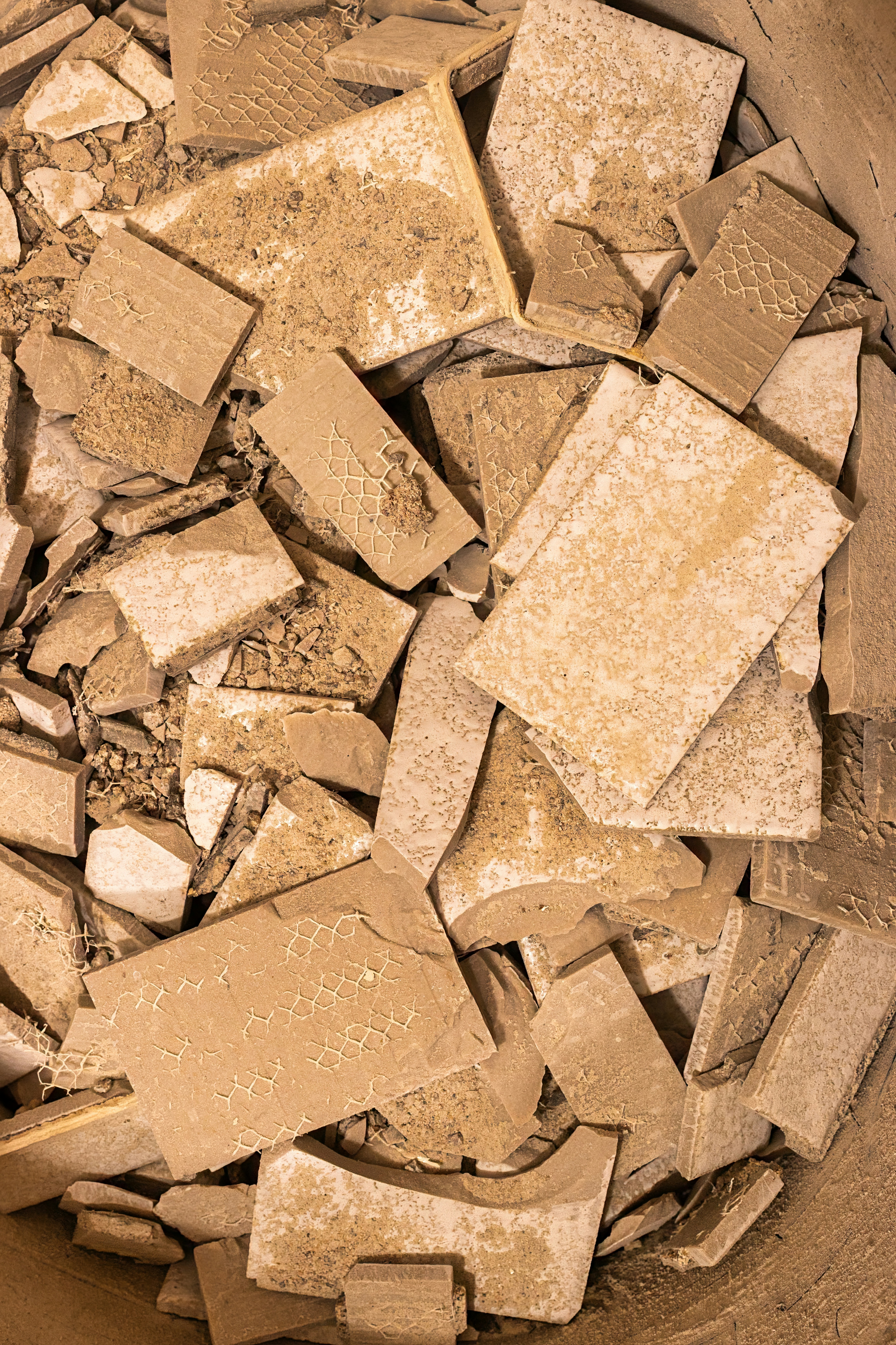 A bowl filled with lots of brown and white tiles