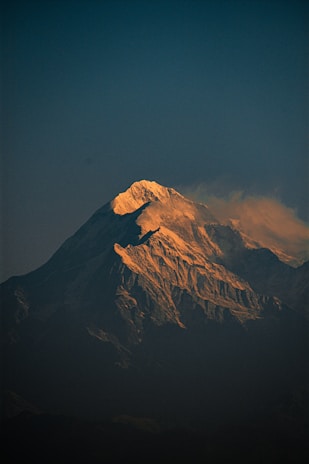 A large snow covered mountain in the distance