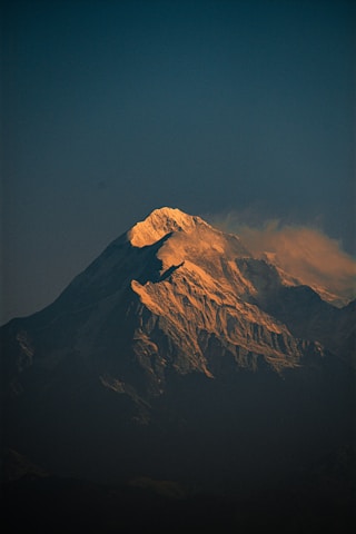 A large snow covered mountain in the distance