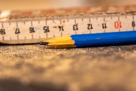 A ruler and a pencil laying on the floor