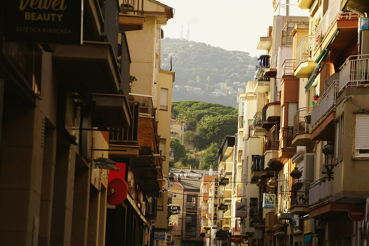 A narrow city street lined with tall buildings