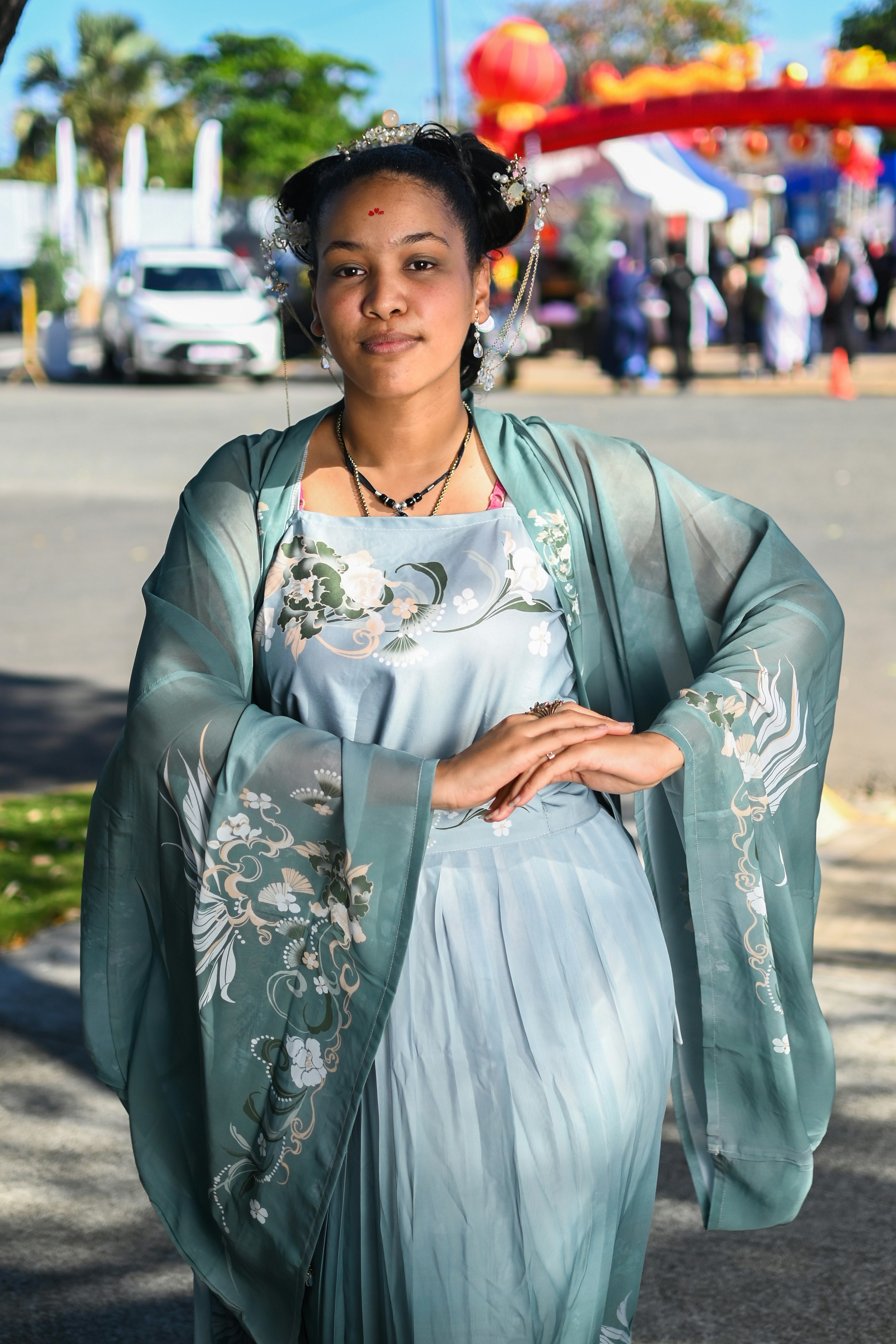 A woman in a blue dress is walking down the street photo – Free Woman ...