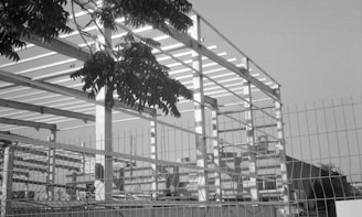 A black and white photo of a fenced in area