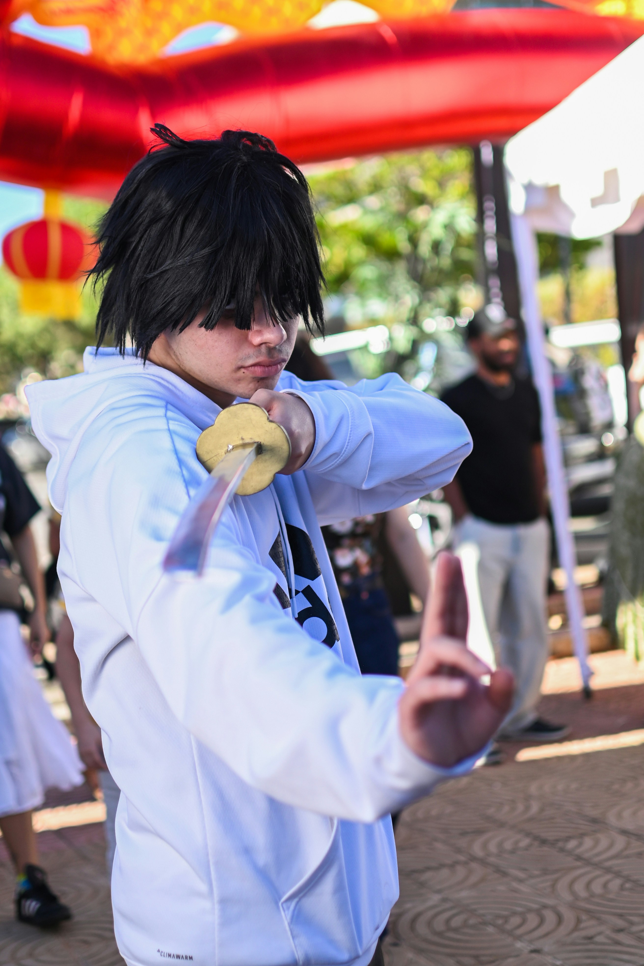 Seorang pria berhoodie putih memegang donat