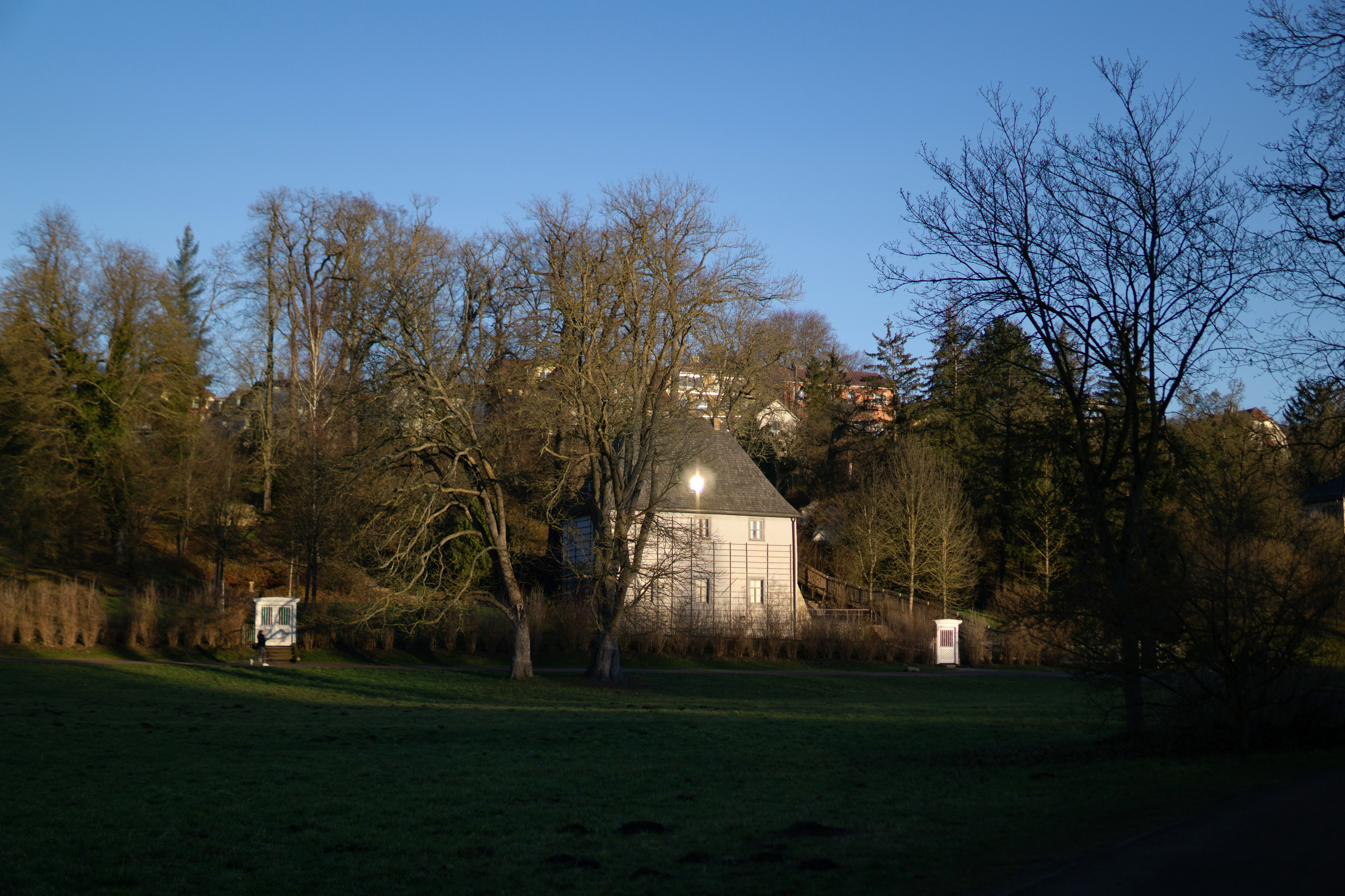 A grassy field with a building in the background