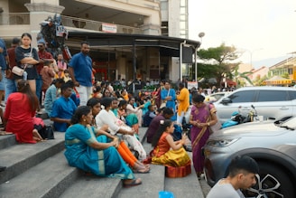 A group of people sitting on the steps of a building