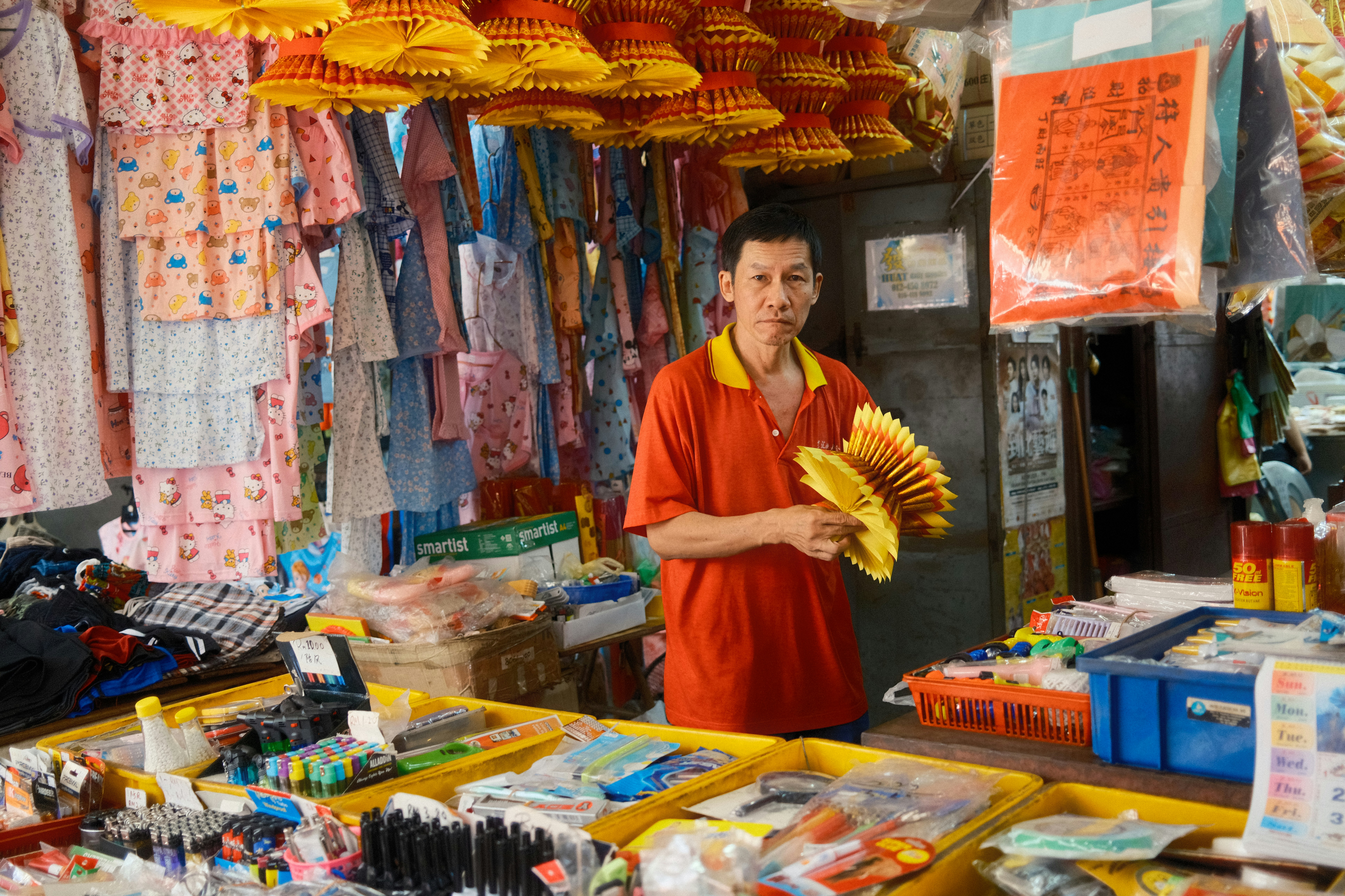 A man standing in front of a store holding a banana