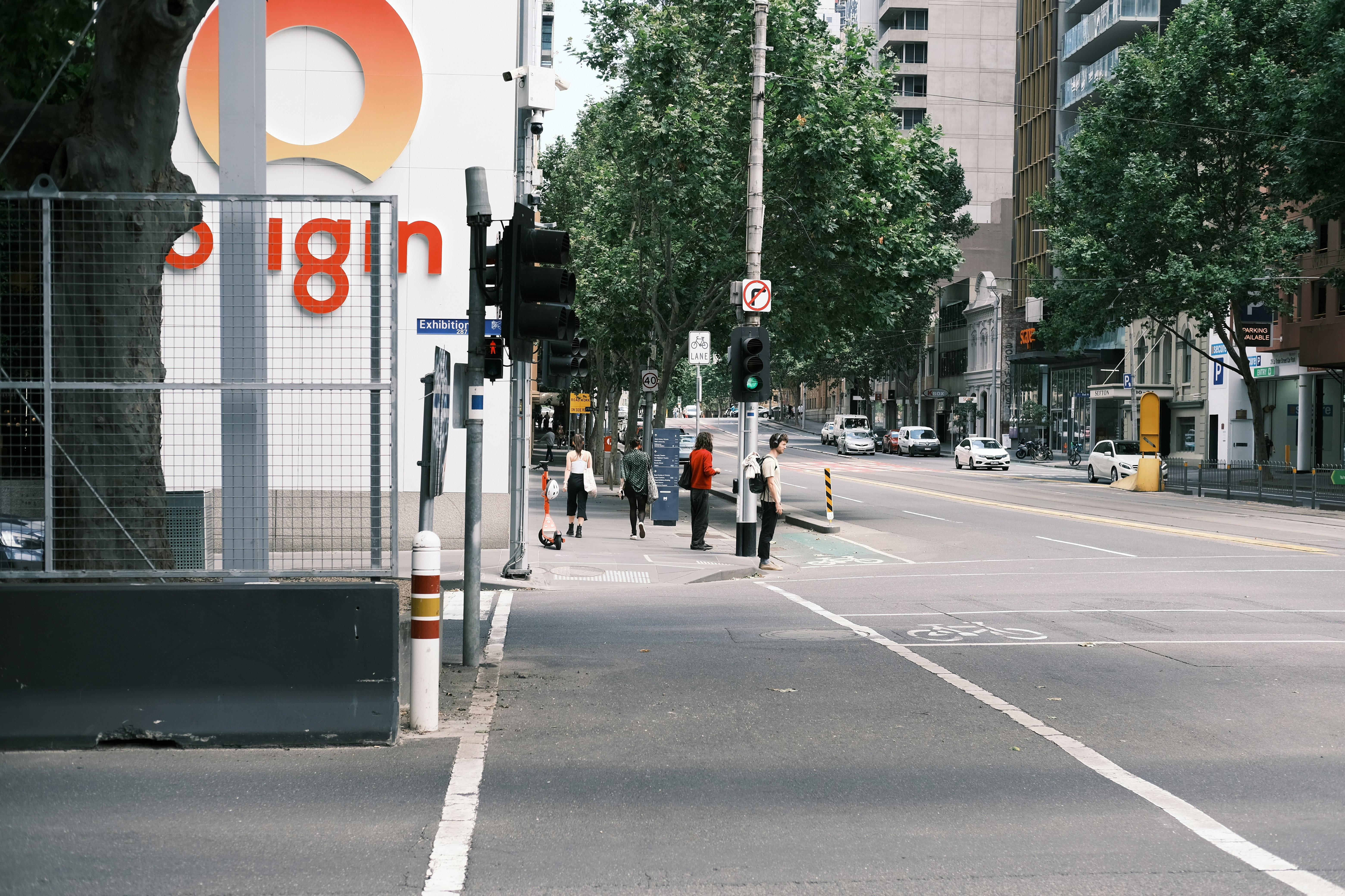 A city street with a large sign on the side of it