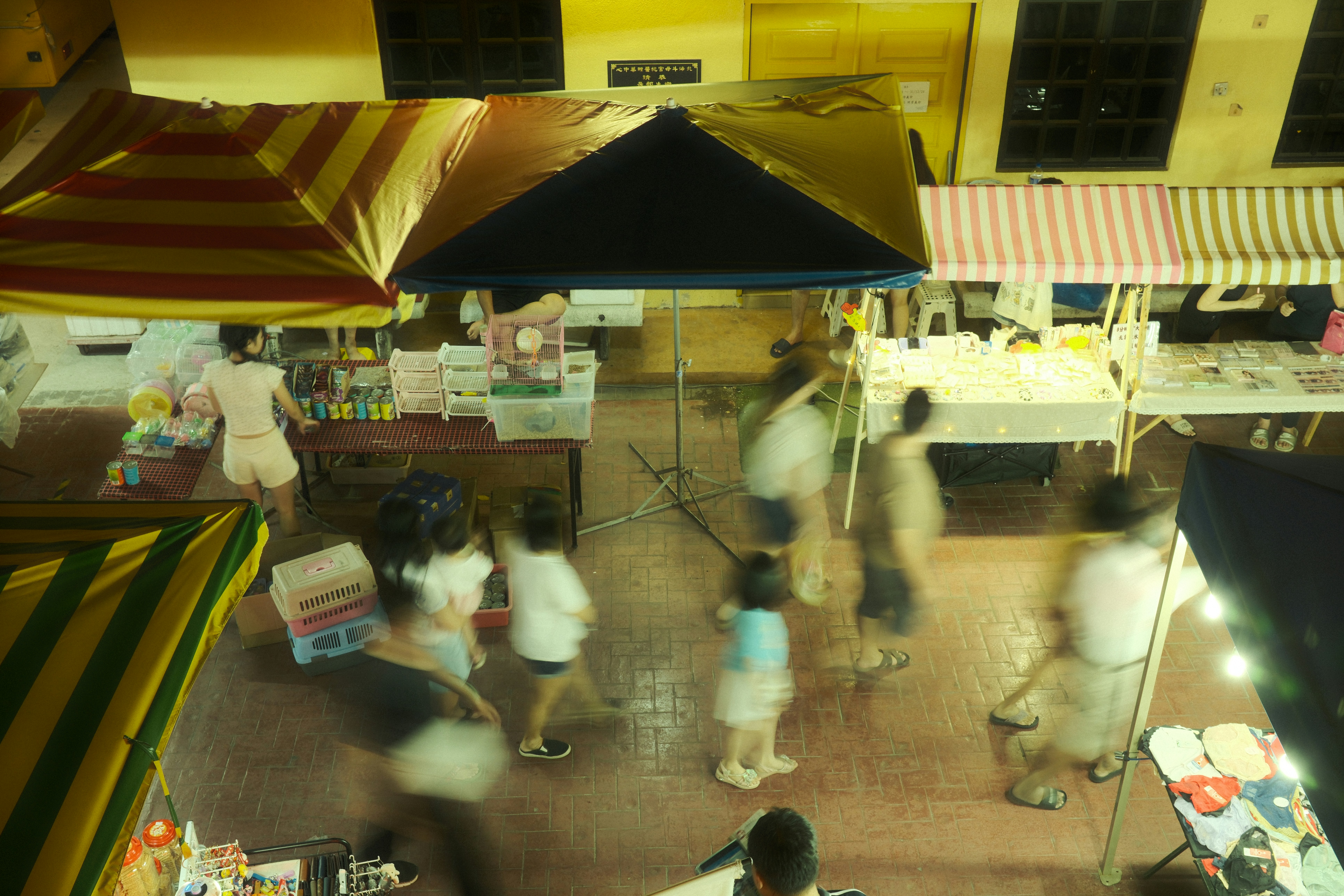 A group of people walking around a market