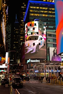 A busy city street at night with tall buildings