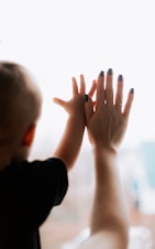 A child's hand giving a high five