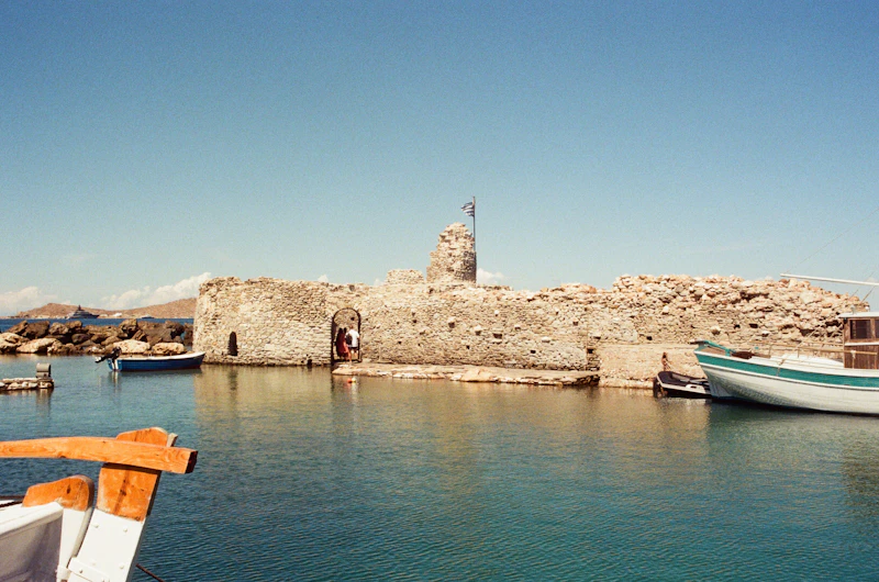 Boat moored by stone wall in Naoussa harbour