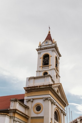 A tall white building with a clock on it's side