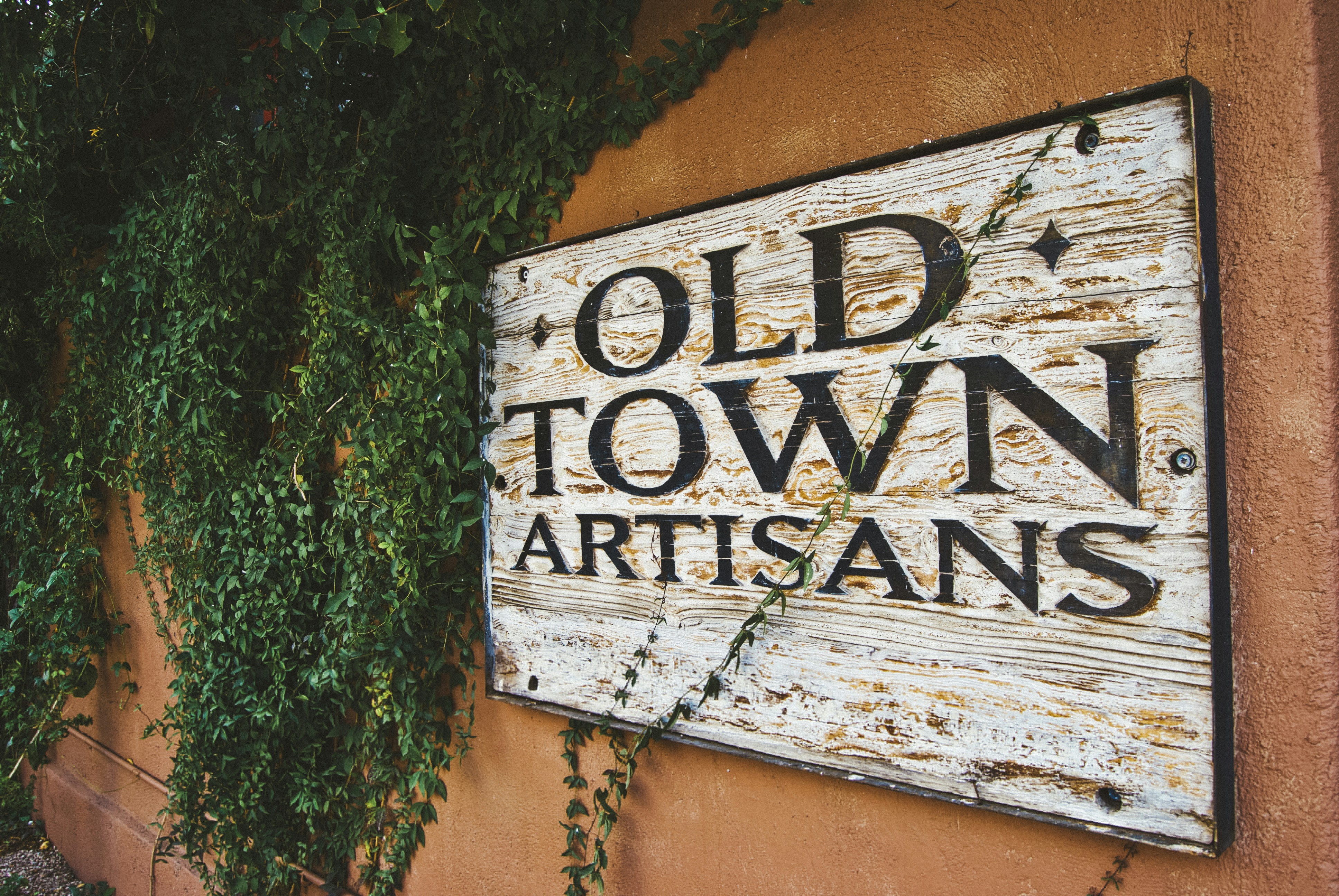 An old town sign on the side of a building