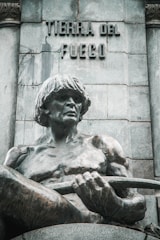 A statue of a man holding a steering wheel