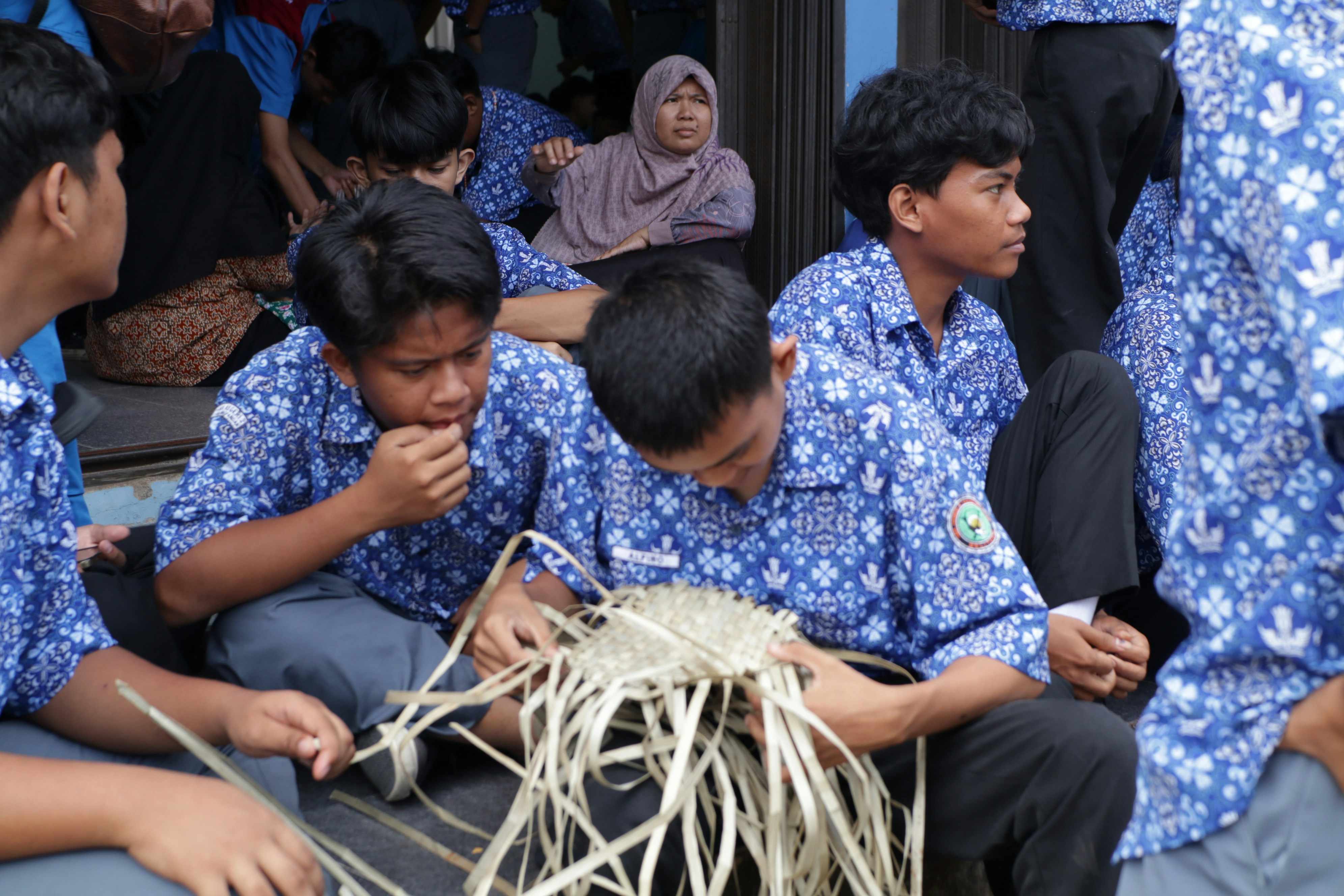 A group of young men sitting next to each other