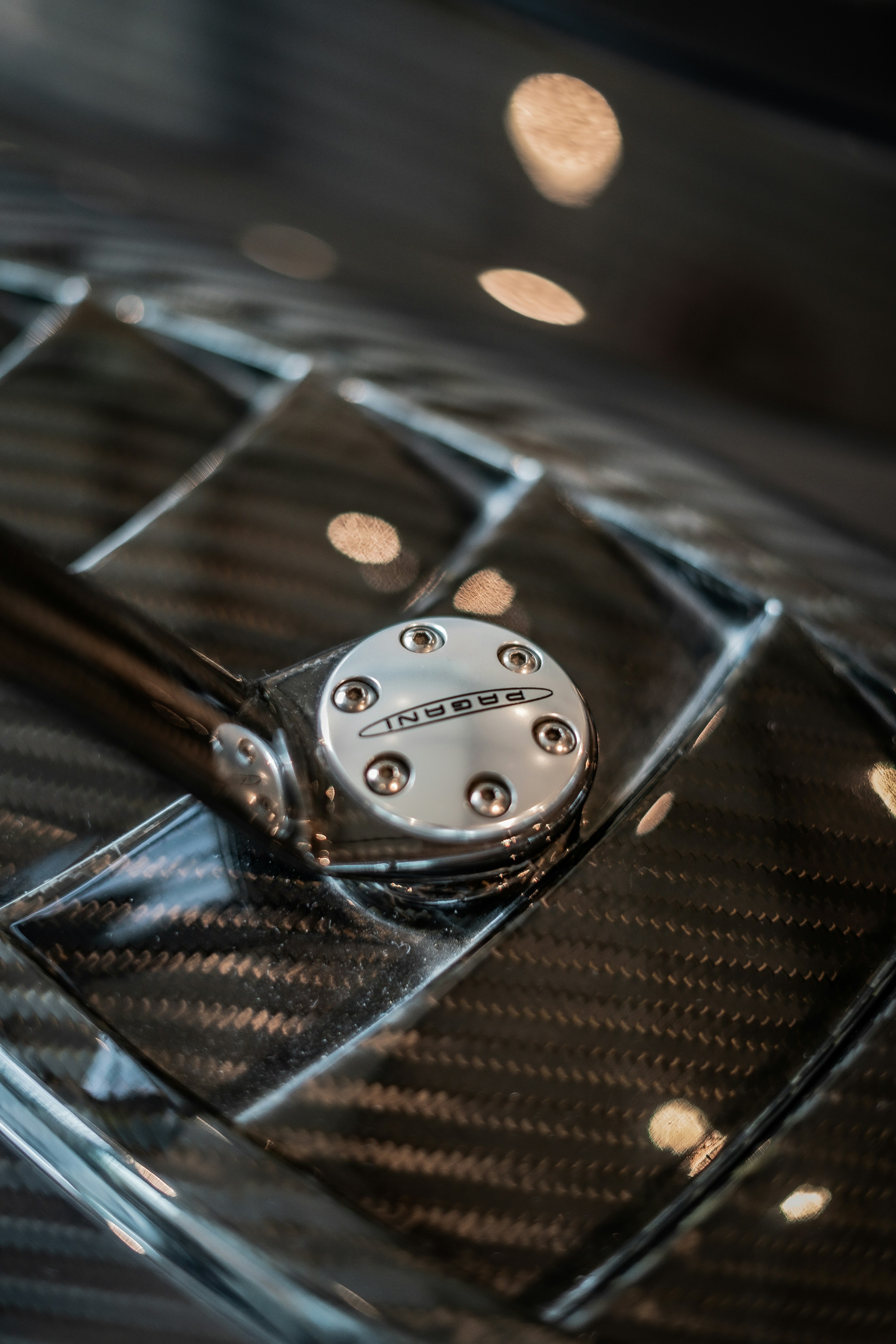 A close up of a metal object on a shiny surface