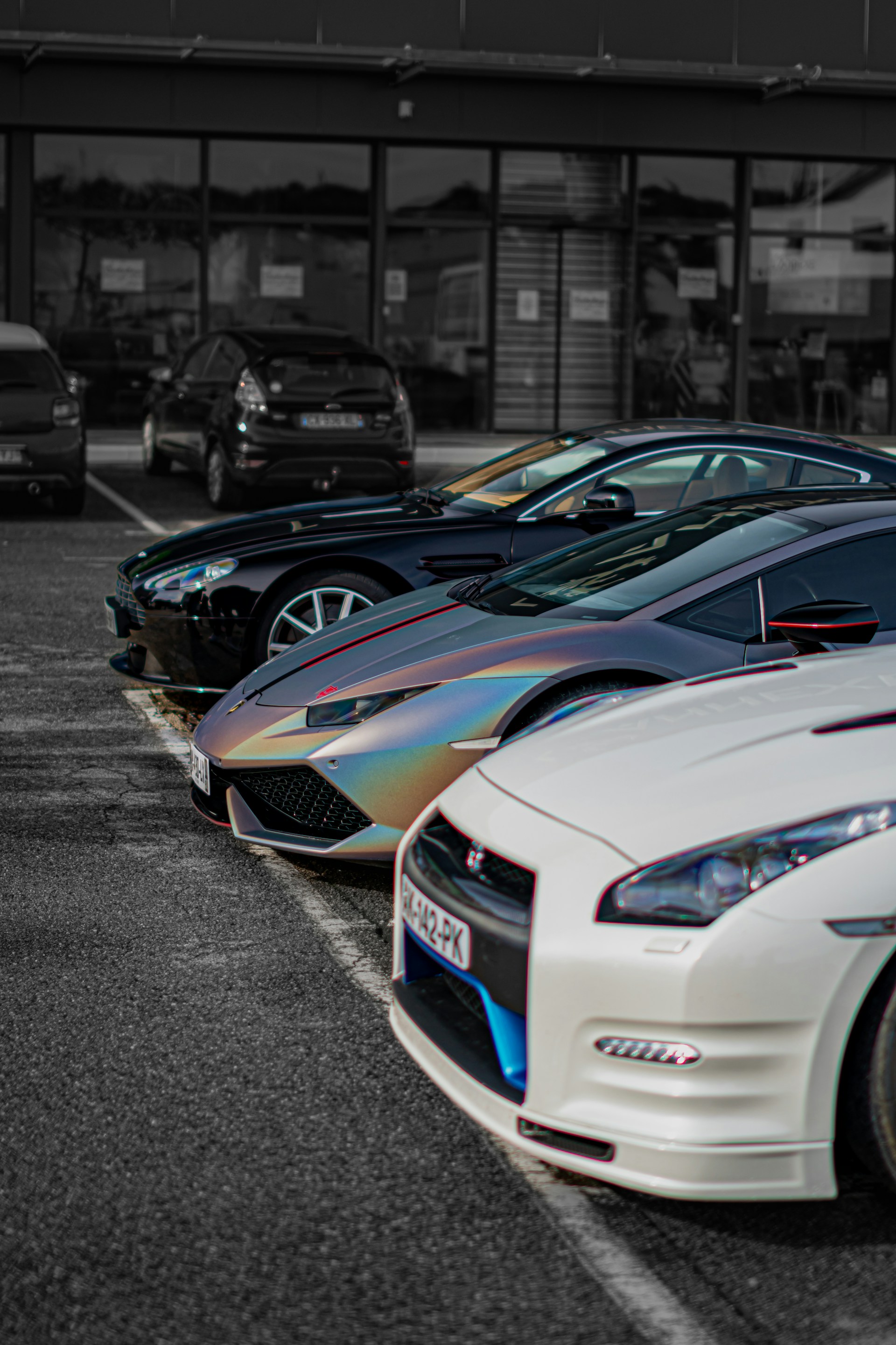 A row of cars parked in a parking lot